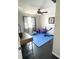 Bright gym featuring workout equipment, dark floors, and a ceiling fan at 548 Big Sioux Ct, Kissimmee, FL 34759