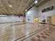 Indoor gymnasium featuring basketball court, scoreboard, and water fountain, providing a space for recreational activities at 548 Big Sioux Ct, Kissimmee, FL 34759