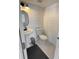 Stylish powder room with a pedestal sink, shiplap walls and modern fixtures at 548 Big Sioux Ct, Kissimmee, FL 34759