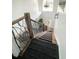 Staircase featuring wooden treads and a decorative metal banister leading to the home's front entrance at 548 Big Sioux Ct, Kissimmee, FL 34759