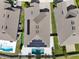 Drone shot featuring a luxury home with solar panels, a pool, and a manicured lawn in a suburban setting at 5499 Orange Orchard Dr, Winter Garden, FL 34787