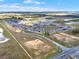 This aerial captures a planned community with views of neighborhood layout, roads and surrounding open land at 5499 Orange Orchard Dr, Winter Garden, FL 34787