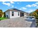 Charming backyard with in-ground pool, paved patio, lush landscape, and solar panels at 5499 Orange Orchard Dr, Winter Garden, FL 34787