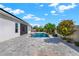 Beautiful backyard pool surrounded by lush landscaping and a spacious paver patio, perfect for outdoor entertaining at 5499 Orange Orchard Dr, Winter Garden, FL 34787