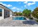 Beautiful backyard pool surrounded by lush landscaping and a spacious paver patio, perfect for outdoor entertaining at 5499 Orange Orchard Dr, Winter Garden, FL 34787