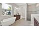 Bright bathroom with soaking tub, large shower, double vanity, and elegant tile flooring at 5499 Orange Orchard Dr, Winter Garden, FL 34787
