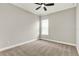 Bedroom with plush carpet flooring, ceiling fan, and natural light from a large window at 5499 Orange Orchard Dr, Winter Garden, FL 34787