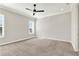 Bright bedroom featuring a ceiling fan, carpeted floors, and ample natural light from windows at 5499 Orange Orchard Dr, Winter Garden, FL 34787