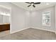 Neutral bedroom with carpet, ceiling fan, and bathroom access at 5499 Orange Orchard Dr, Winter Garden, FL 34787