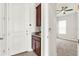 Entryway featuring a granite counter, brown cabinets and gray carpet at 5499 Orange Orchard Dr, Winter Garden, FL 34787