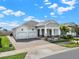 A charming single-story home with a paver driveway and a well-manicured lawn at 5499 Orange Orchard Dr, Winter Garden, FL 34787