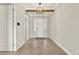 Bright foyer featuring wood-look tile floors, a decorative light fixture and white trim at 5499 Orange Orchard Dr, Winter Garden, FL 34787
