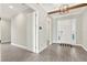 Welcoming foyer with wood-look tile flooring, elegant lighting, and neutral walls at 5499 Orange Orchard Dr, Winter Garden, FL 34787