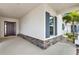 Inviting covered entryway with stone accents and a view of the front door at 5499 Orange Orchard Dr, Winter Garden, FL 34787