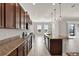 Well-equipped kitchen featuring granite countertops, stainless steel appliances, and a center island with a sink at 5499 Orange Orchard Dr, Winter Garden, FL 34787