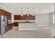 Open kitchen boasts stainless steel appliances, granite countertops, and an island with pendant lighting at 5499 Orange Orchard Dr, Winter Garden, FL 34787