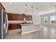 Modern kitchen with a central island, granite countertops, and stainless steel appliances at 5499 Orange Orchard Dr, Winter Garden, FL 34787