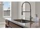 Kitchen island featuring granite countertop and stainless steel faucet with a goose neck design at 5499 Orange Orchard Dr, Winter Garden, FL 34787