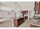 Kitchen with center island, stainless steel appliances, and open layout to other living spaces at 5499 Orange Orchard Dr, Winter Garden, FL 34787