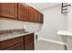Functional laundry room with granite counters and wood cabinetry at 5499 Orange Orchard Dr, Winter Garden, FL 34787