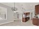 Open-plan living space with kitchen island, neutral decor, and abundant natural light at 5499 Orange Orchard Dr, Winter Garden, FL 34787