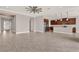 Spacious open-plan living room and kitchen area, bright with natural light, and modern ceiling fan at 5499 Orange Orchard Dr, Winter Garden, FL 34787
