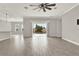 Open-concept living room with tile flooring and a sliding glass door leading to the pool area at 5499 Orange Orchard Dr, Winter Garden, FL 34787