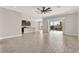 Open-concept living space with tile flooring, kitchen island and sliding glass doors to the pool area at 5499 Orange Orchard Dr, Winter Garden, FL 34787