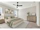 Serene main bedroom featuring a ceiling fan, a large bed with decorative pillows, and a dresser at 5499 Orange Orchard Dr, Winter Garden, FL 34787