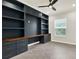 Office space with custom built-in bookshelves, desk, and neutral color palette at 5499 Orange Orchard Dr, Winter Garden, FL 34787