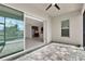 Covered patio featuring tile flooring, exterior views, and natural light entering the kitchen area at 5499 Orange Orchard Dr, Winter Garden, FL 34787