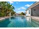 Inviting backyard pool featuring clear blue water, lush landscaping, and ample space for outdoor enjoyment at 5499 Orange Orchard Dr, Winter Garden, FL 34787