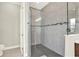 Modern bathroom shower featuring gray tile, glass doors, and sleek fixtures at 5499 Orange Orchard Dr, Winter Garden, FL 34787