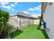 Practical side yard with artificial turf, great for low-maintenance landscaping and outdoor storage solutions at 5499 Orange Orchard Dr, Winter Garden, FL 34787