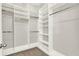 Spacious walk-in closet with custom shelving, organizers, and ample storage space at 5499 Orange Orchard Dr, Winter Garden, FL 34787