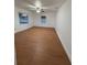 Bright bedroom featuring hardwood floors, a ceiling fan, and large windows for natural light at 636 Coke Ave, Winter Garden, FL 34787