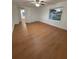 Spacious bedroom featuring wood-look floors, ceiling fan, and natural light from a window at 636 Coke Ave, Winter Garden, FL 34787