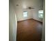 Bright bedroom with wood-look floors, ceiling fan, and natural light from two windows at 636 Coke Ave, Winter Garden, FL 34787