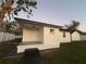 View of home's side exterior, showing tiled porch and detached garage at 636 Coke Ave, Winter Garden, FL 34787