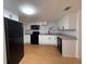 Modern kitchen featuring new white cabinetry, granite countertops, and stainless steel appliances at 636 Coke Ave, Winter Garden, FL 34787