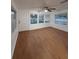 Bright living room with new wood flooring, plenty of light from multiple windows, and a ceiling fan at 636 Coke Ave, Winter Garden, FL 34787