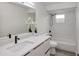 Bathroom featuring a quartz countertop, shower with glass door, and a decorative plant at 7549 Dockside St, Winter Park, FL 32792