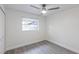 Bright bedroom with light grey flooring, ceiling fan, and white trim at 7549 Dockside St, Winter Park, FL 32792