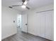 Inviting bedroom with modern ceiling fan, light grey flooring, and access to an ensuite bathroom at 7549 Dockside St, Winter Park, FL 32792