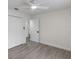 Spacious bedroom with wood-look flooring, ceiling fan, and ample closet space at 7549 Dockside St, Winter Park, FL 32792