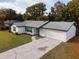 Charming single Gathering home with a well maintained front yard and long private driveway at 7549 Dockside St, Winter Park, FL 32792