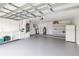 This is an open and spacious two car garage with a refrigerator and plenty of shelving at 7549 Dockside St, Winter Park, FL 32792