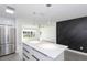 Bright living room with an open floor plan to kitchen featuring modern backsplash and flooring at 7549 Dockside St, Winter Park, FL 32792