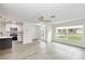 Bright living room with a ceiling fan, large window and an open floor plan at 7549 Dockside St, Winter Park, FL 32792