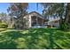 A screened porch sits behind a manicured lawn on this homes large and private back yard at 781 Lakeworth Cir, Lake Mary, FL 32746